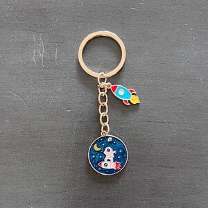 Astronaut Riding Surfing Rocket Spaceship Yellow Star Enamel 3.5" Gold Keychain